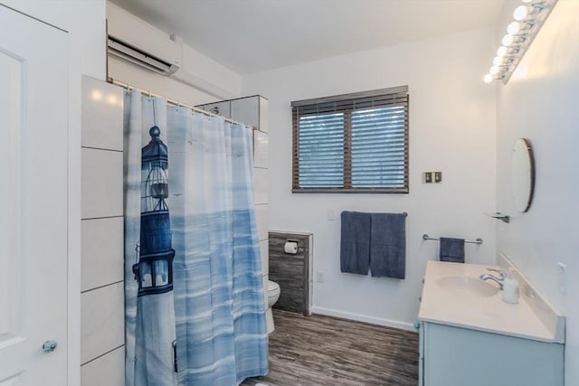 bathroom with a wall mounted AC, hardwood / wood-style flooring, vanity, walk in shower, and toilet