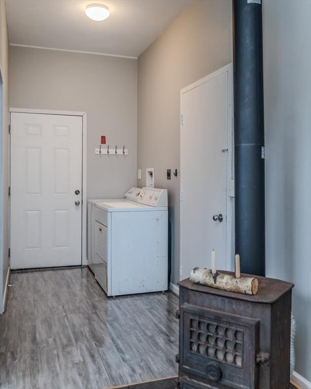 laundry area with hardwood / wood-style floors and washer and clothes dryer