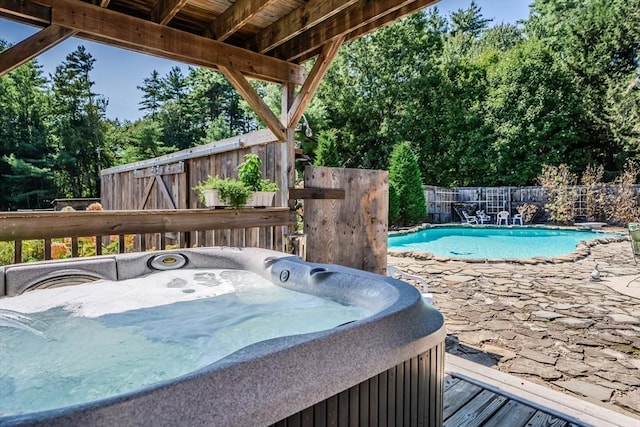 view of pool with a hot tub