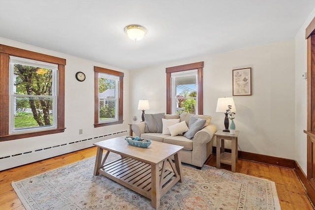 49 Maple St, Oakham, MA 01068 - living area with a baseboard radiator, healthy amount of natural light, and light wood-style floors