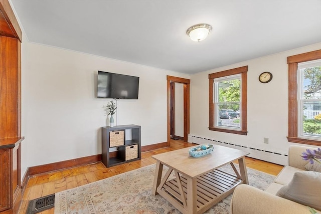 49 Maple St, Oakham, MA 01068 - living room with a baseboard heating unit, baseboards, and light wood-style floors