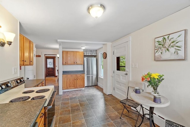 49 Maple St, Oakham, MA 01068 - kitchen featuring freestanding refrigerator, range with electric cooktop, dark countertops, dark stone finish flooring, and a baseboard radiator