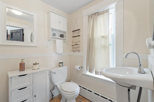 49 Maple St, Oakham, MA 01068 - full bath featuring a baseboard radiator, toilet, plenty of natural light, and shower / tub combo with curtain