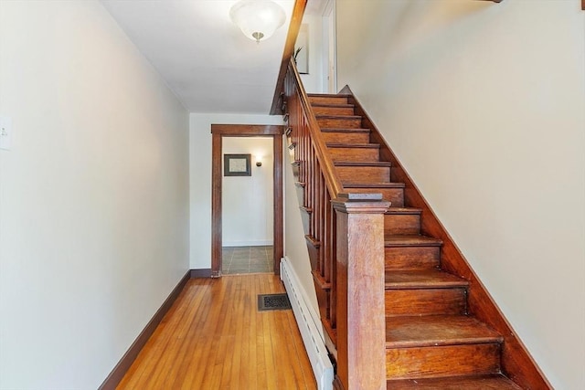 49 Maple St, Oakham, MA 01068 - staircase featuring wood-type flooring, a baseboard radiator, and baseboards