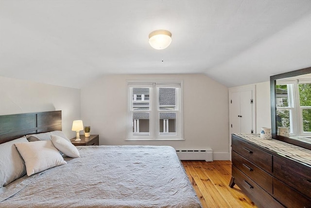 49 Maple St, Oakham, MA 01068 - bedroom with a baseboard radiator, light wood finished floors, lofted ceiling, and baseboards