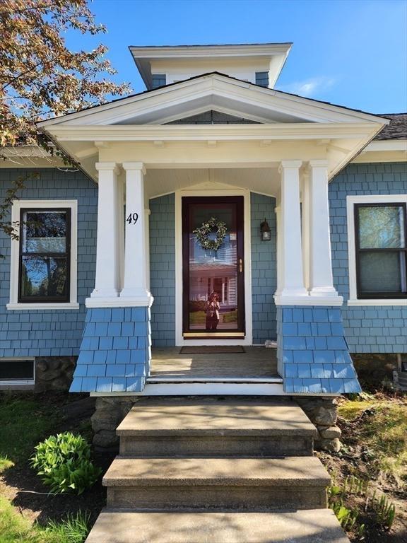 49 Maple St, Oakham, MA 01068 - property entrance with covered porch and brick siding