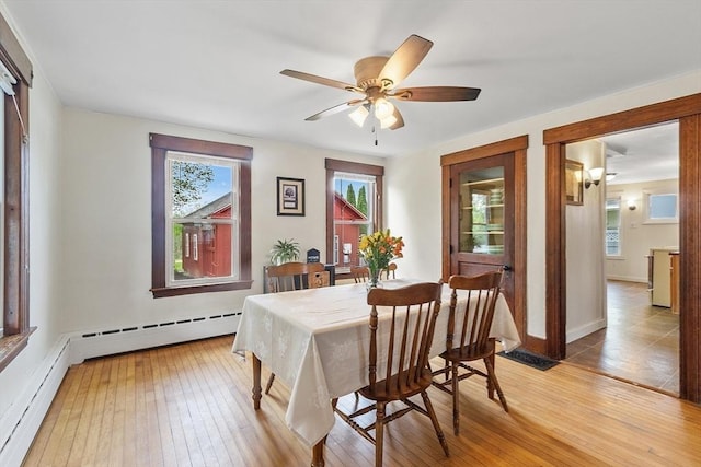 49 Maple St, Oakham, MA 01068 - dining space with a baseboard heating unit, light wood-style flooring, plenty of natural light, and a ceiling fan