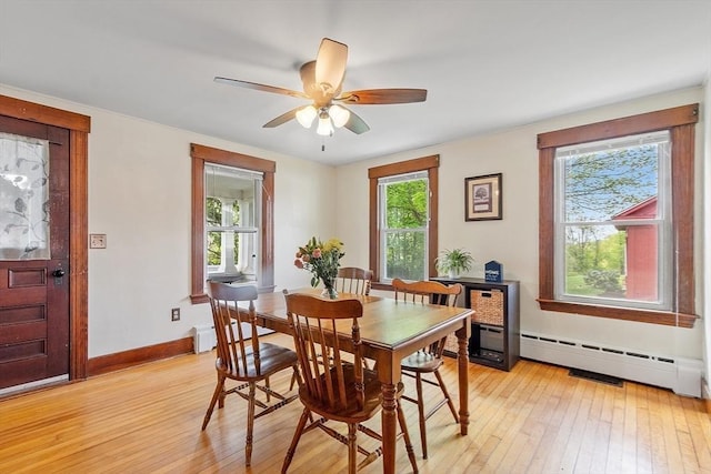 49 Maple St, Oakham, MA 01068 - dining area with light wood-style floors, plenty of natural light, and a baseboard heating unit