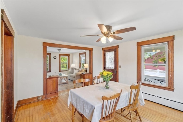 49 Maple St, Oakham, MA 01068 - dining room with a baseboard radiator, light wood-style flooring, baseboards, ceiling fan, and plenty of natural light