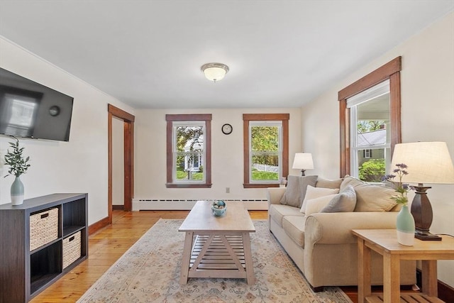 49 Maple St, Oakham, MA 01068 - living area featuring healthy amount of natural light, light wood-style floors, baseboard heating, and baseboards
