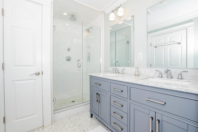 full bathroom featuring crown molding, a stall shower, a sink, and double vanity