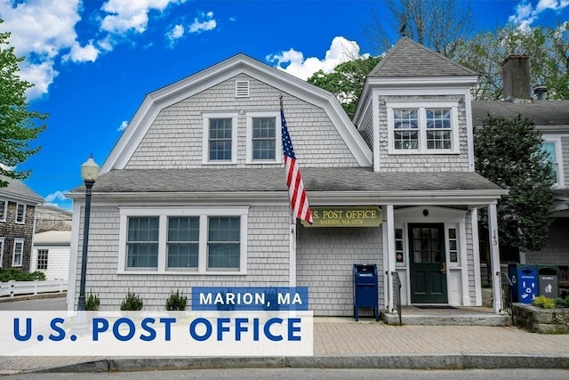 view of front of home with a shingled roof and a gambrel roof