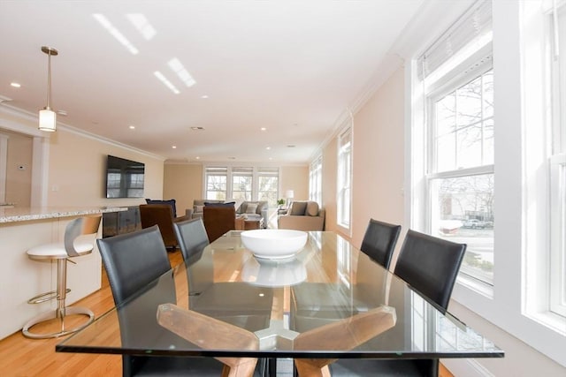 dining space featuring ornamental molding, wood finished floors, and recessed lighting