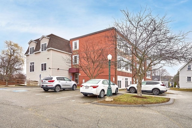 46 Ashford Unit 14, Methuen, MA 01844 - view of side of home with uncovered parking and a shingled roof