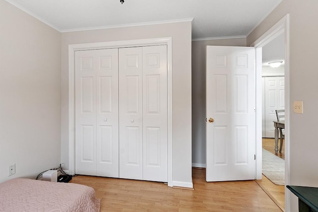 46 Ashford Unit 14, Methuen, MA 01844 - bedroom featuring light wood-style floors, ornamental molding, and a closet