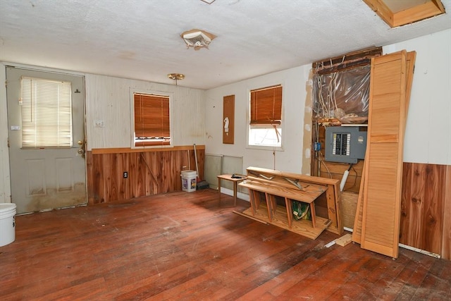 miscellaneous room featuring dark hardwood / wood-style flooring and wooden walls