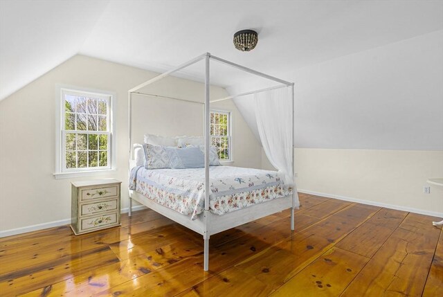 bedroom featuring vaulted ceiling and hardwood / wood-style floors