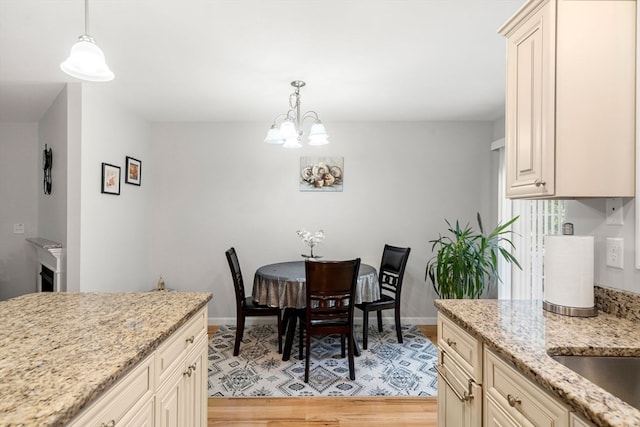 dining space with an inviting chandelier and light wood-type flooring