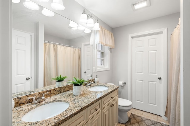 bathroom with vanity, tile patterned floors, and toilet