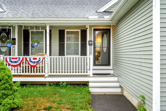 view of exterior entry with a porch