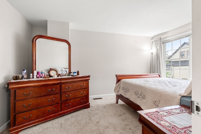 bedroom featuring light carpet