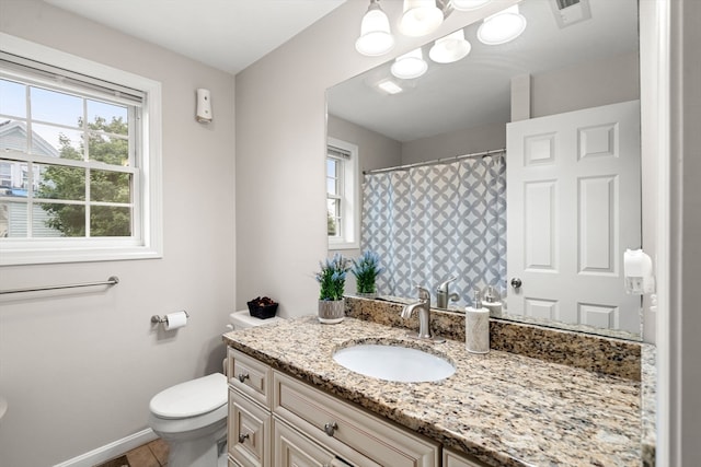 bathroom with tile patterned floors, vanity, and toilet