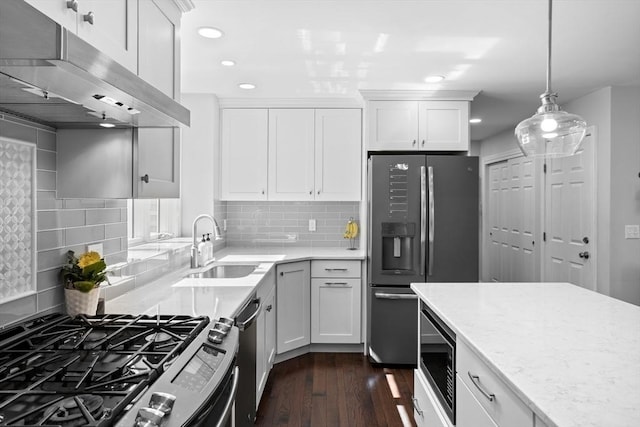 kitchen with a sink, dark wood-style floors, under cabinet range hood, stainless steel appliances, and recessed lighting