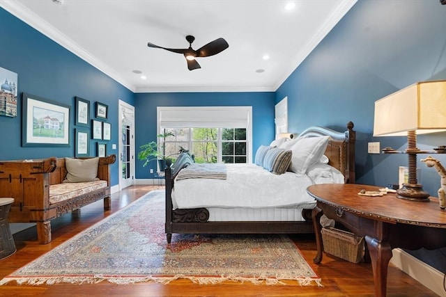 bedroom with baseboards, ornamental molding, and wood finished floors