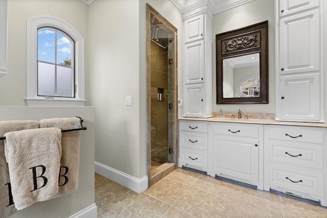 full bath with crown molding, a stall shower, baseboards, vanity, and tile patterned floors