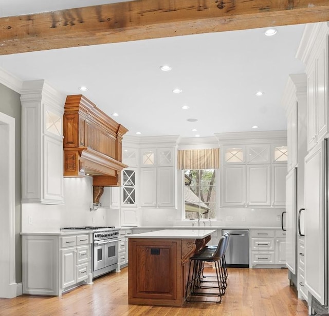 kitchen featuring light countertops, white cabinets, and stainless steel appliances