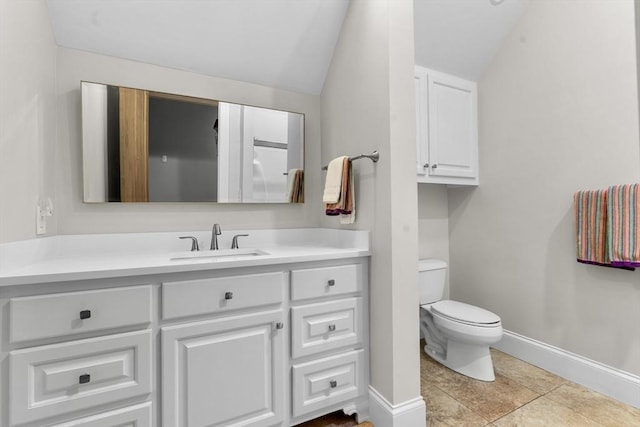 bathroom featuring tile patterned flooring, vaulted ceiling, vanity, baseboards, and toilet
