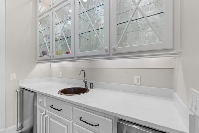 bar with a sink, refrigerator, and beverage cooler