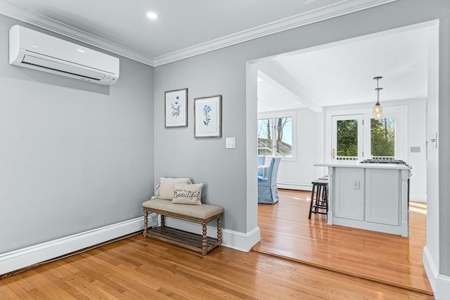 sitting room featuring crown molding, a wall mounted AC, baseboard heating, baseboards, and light wood-style floors