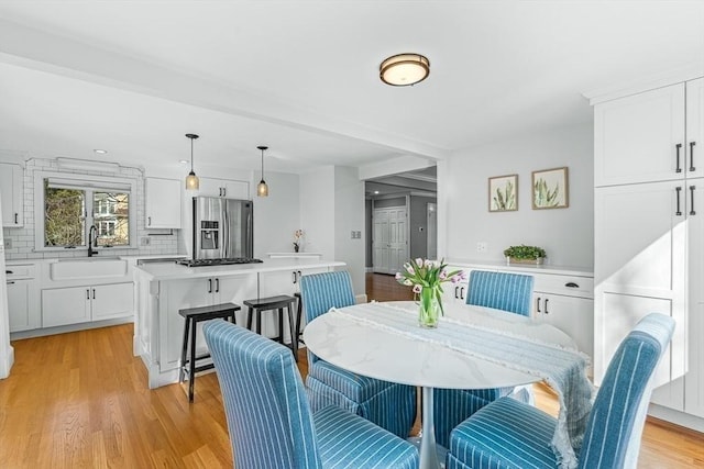 dining area featuring light wood-style floors