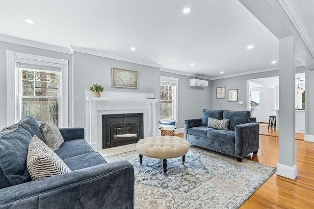 living room with recessed lighting, light wood finished floors, and a wall mounted air conditioner