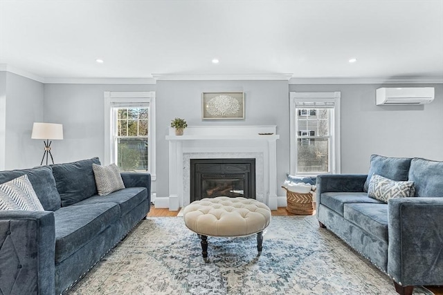 living room with ornamental molding, a glass covered fireplace, wood finished floors, recessed lighting, and a wall unit AC