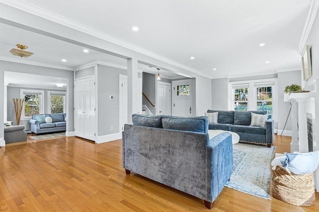 living room with light wood-style floors, recessed lighting, stairs, and baseboards