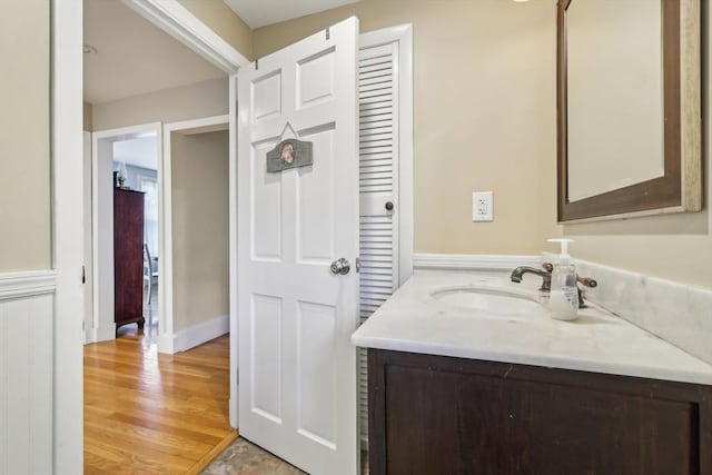 bathroom with wood finished floors and vanity