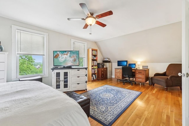 bedroom featuring vaulted ceiling, a ceiling fan, and wood finished floors