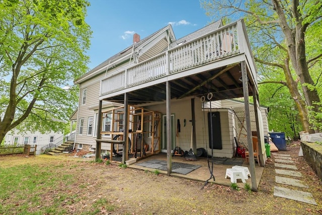 back of house with a wooden deck