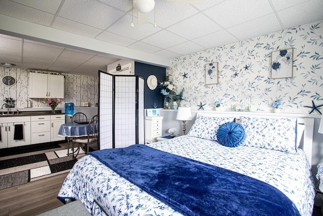 139 Barneyville Rd, Swansea, MA 02777 - bedroom with wallpapered walls, a paneled ceiling, dark wood-style flooring, and a sink
