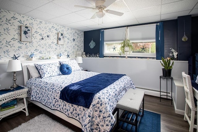 139 Barneyville Rd, Swansea, MA 02777 - bedroom with a baseboard radiator, a paneled ceiling, wallpapered walls, wood finished floors, and ceiling fan
