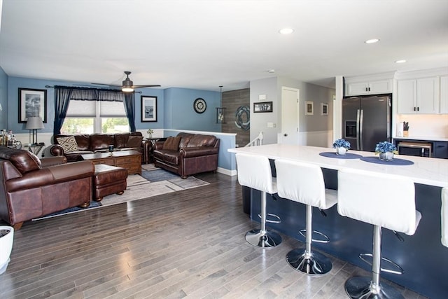 139 Barneyville Rd, Swansea, MA 02777 - kitchen featuring appliances with stainless steel finishes, white cabinetry, a breakfast bar area, a ceiling fan, and dark wood finished floors