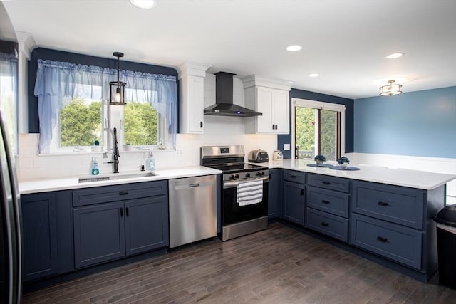 139 Barneyville Rd, Swansea, MA 02777 - kitchen featuring wall chimney exhaust hood, stainless steel appliances, a sink, a peninsula, and light countertops