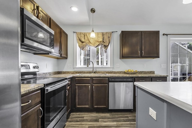 1 Lois Ln, Townsend, MA 01469 - kitchen featuring decorative light fixtures, appliances with stainless steel finishes, dark brown cabinets, a sink, and dark wood-type flooring