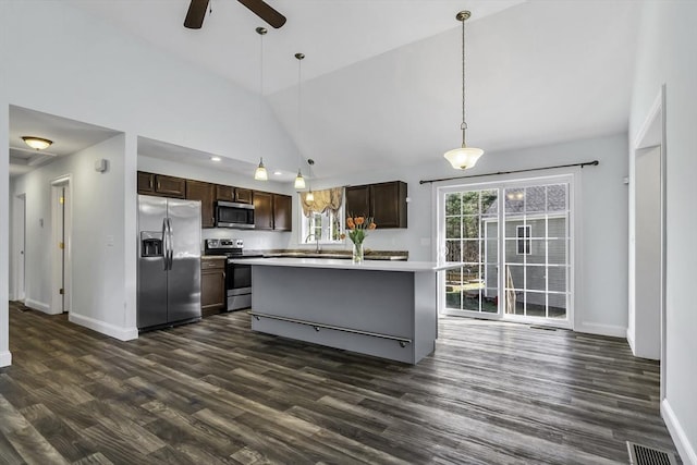 1 Lois Ln, Townsend, MA 01469 - kitchen featuring dark brown cabinets, baseboards, ceiling fan, appliances with stainless steel finishes, and vaulted ceiling