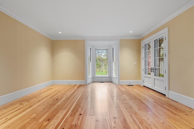 spare room featuring wood-type flooring, recessed lighting, baseboards, and ornamental molding