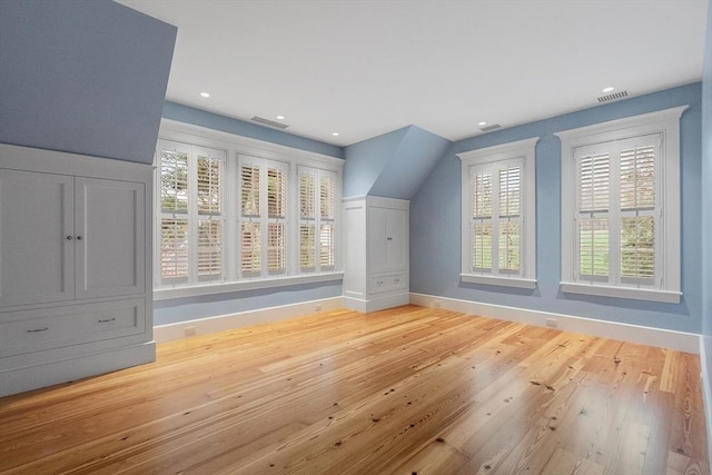 additional living space with recessed lighting, baseboards, light wood finished floors, and visible vents
