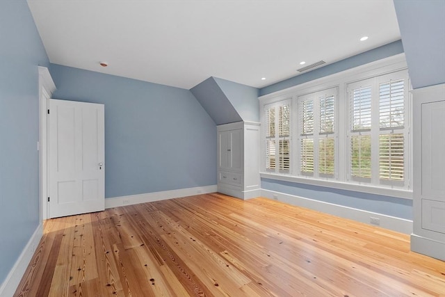additional living space with recessed lighting, baseboards, visible vents, and hardwood / wood-style flooring