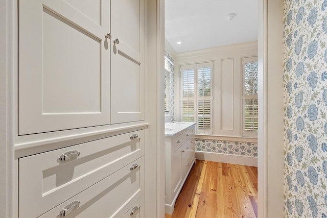interior space with vanity and wood finished floors